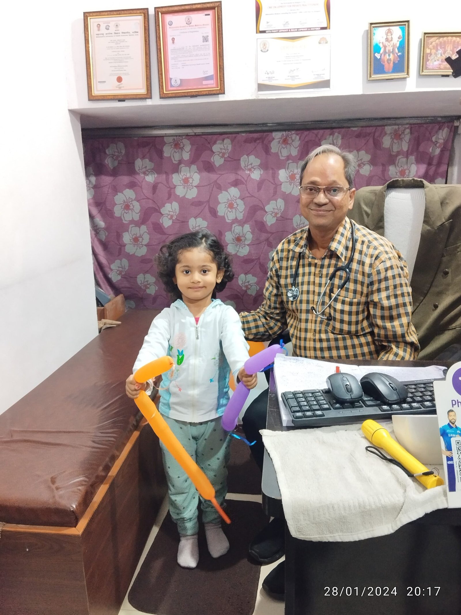 A cheerful 4-year-old baby patient visiting Dr. N. A. Dharmadhikari for follow-up after recovering from chest infection