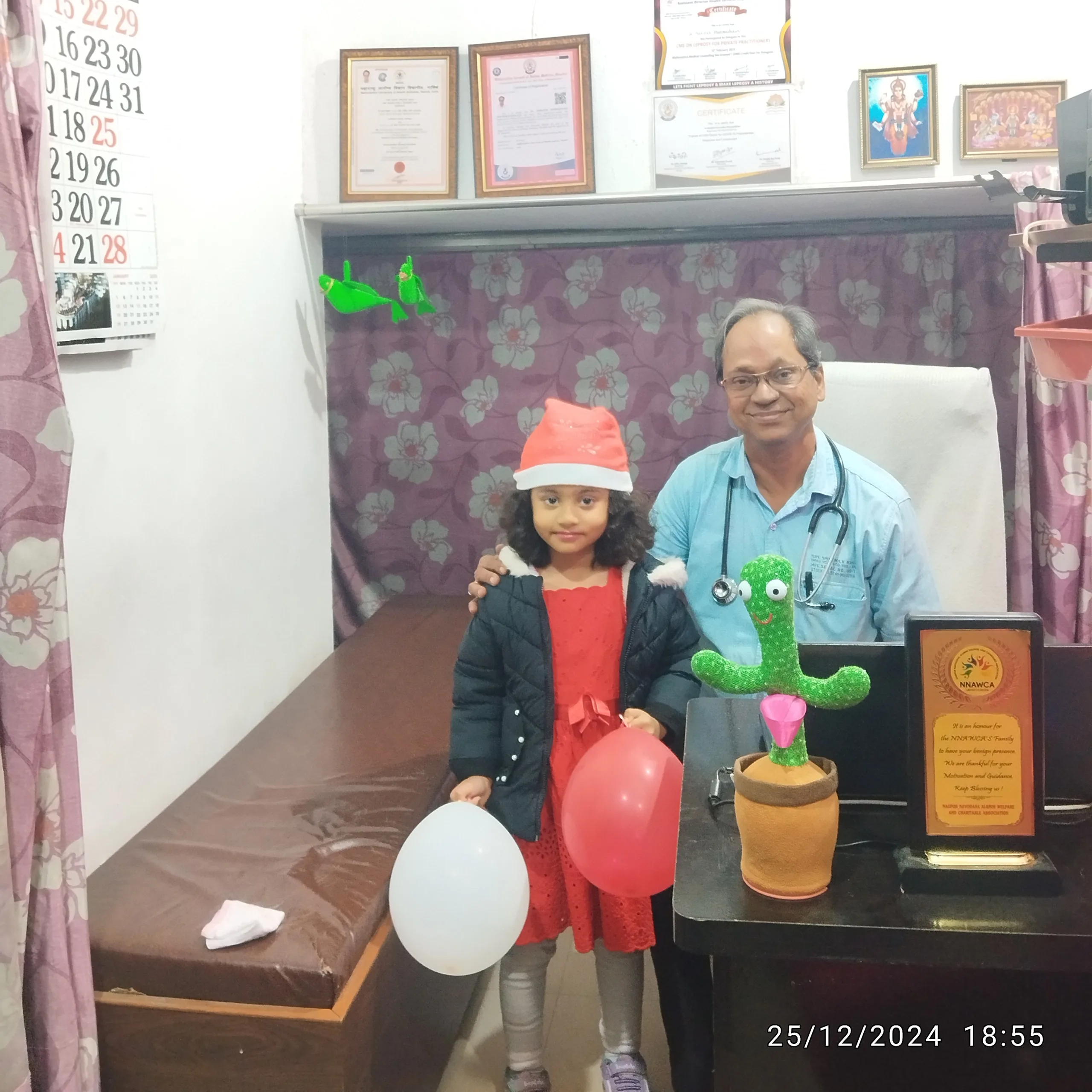 Young child dressed as Santa Claus visiting Dr. N. A. Dharmadhikari Clinic during the festive season.