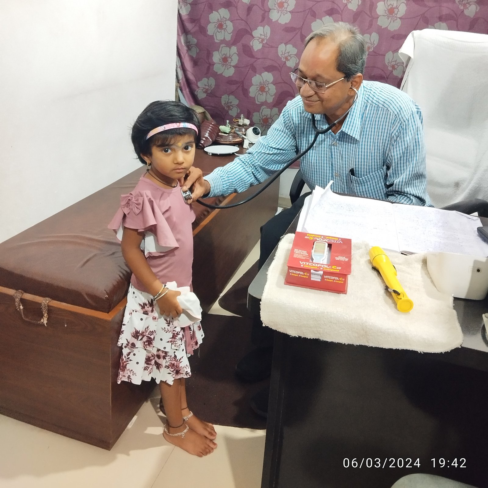 Young girl calmly undergoing chest examination.