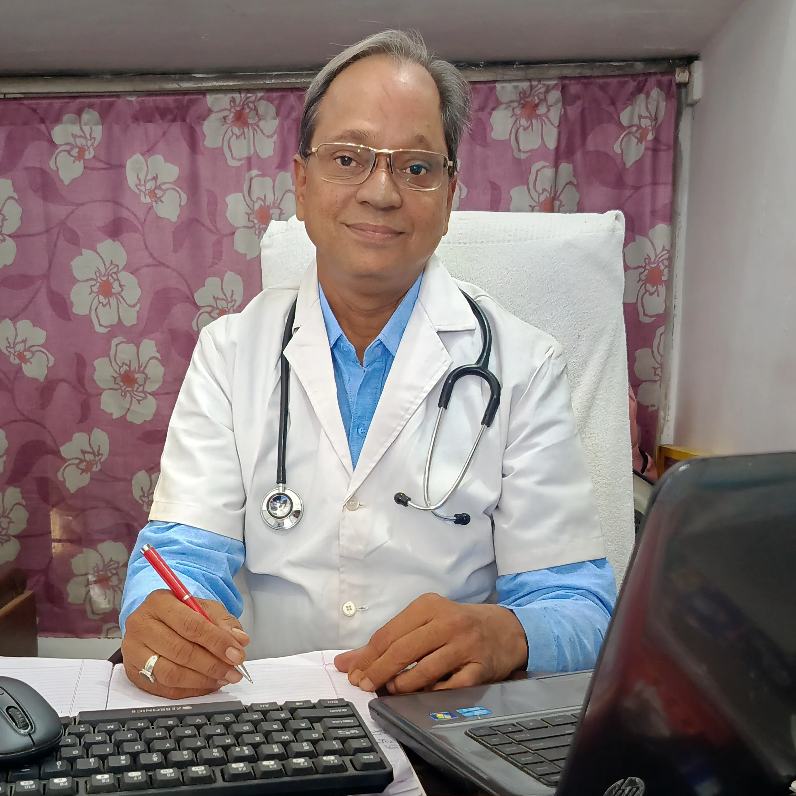 Dr. N. A. Dharmadhikari in the clinic consultation chamber welcoming patients.