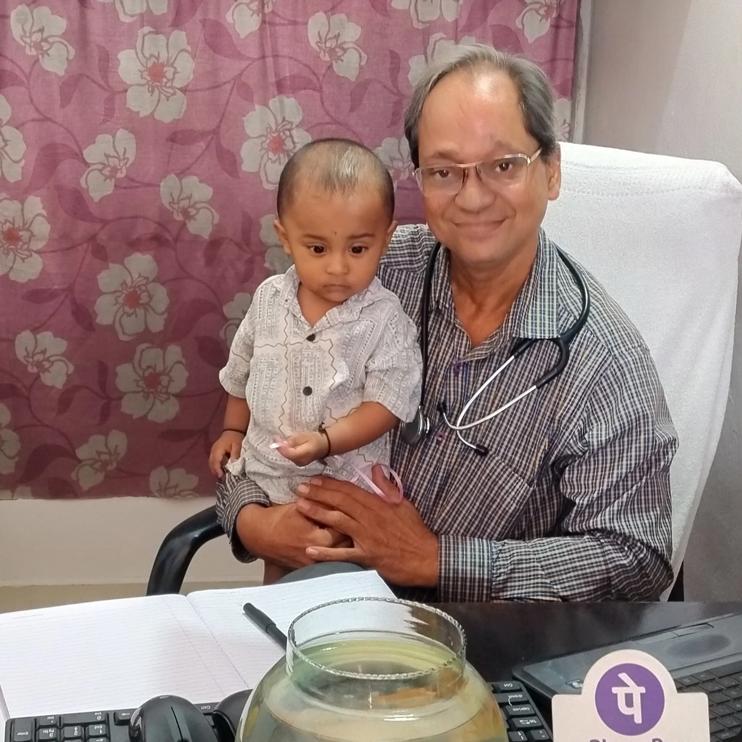 Toddler boy resting comfortably during clinical consultation.